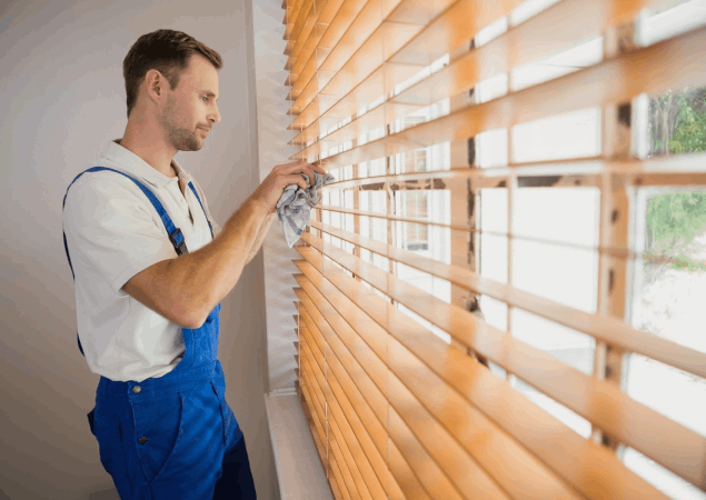 Worker repairing blinds